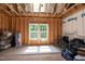 Unfinished room featuring exposed framing, a window, and items stored to show potential use at 1820 Yates Wheel Way, Raleigh, NC 27606