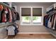 Bright walk-in closet with built-in shelving and double-hung windows, with lots of room for organization at 1820 Yates Wheel Way, Raleigh, NC 27606