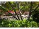 Charming backyard featuring a stone retaining wall with vibrant flowers and lush greenery, offering a peaceful retreat at 19 Oak Dr, Durham, NC 27707