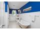 Elegant blue and white bathroom features a clawfoot tub and wainscotting at 19 Oak Dr, Durham, NC 27707