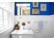 Bathroom features white walls, wainscotting, blue accent wall and stylish fixtures at 19 Oak Dr, Durham, NC 27707