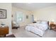 Cozy bedroom with upholstered chair, soft natural light and light yellow walls at 19 Oak Dr, Durham, NC 27707