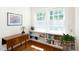 Bedroom with hardwood floors and built-in shelving and large window with natural light at 19 Oak Dr, Durham, NC 27707