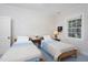 Quaint bedroom with twin beds, cozy decor, and light floral wallpaper at 19 Oak Dr, Durham, NC 27707
