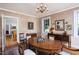 Elegant dining room with floral wallpaper, wood furnishings, and a chandelier at 19 Oak Dr, Durham, NC 27707