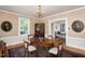 Formal dining room with hardwood floors, floral wallpaper, and wood furniture at 19 Oak Dr, Durham, NC 27707