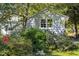 Quaint home exterior nestled among lush trees and greenery, offering a peaceful and private setting at 19 Oak Dr, Durham, NC 27707