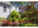 Charming home exterior framed by lush greenery and vibrant flowers, creating a picturesque and inviting curb appeal at 19 Oak Dr, Durham, NC 27707