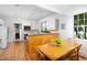 Bright kitchen with white cabinets, breakfast bar, and adjacent dining area at 19 Oak Dr, Durham, NC 27707