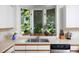 Close-up of a kitchen sink under a bay window surrounded by plants and stainless steel appliances at 19 Oak Dr, Durham, NC 27707