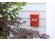 Unique red mailbox with the word 'POST' and a horn design, mounted on a white wall at 19 Oak Dr, Durham, NC 27707