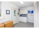 Bright mudroom featuring white cabinetry, a sink, and a glass-paneled door at 19 Oak Dr, Durham, NC 27707