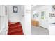 Charming mudroom featuring red-stained wooden stairs and tiled floors adjacent to the entry door at 19 Oak Dr, Durham, NC 27707