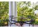 Inviting outdoor porch featuring an elegant wrought iron table and chairs for relaxing or entertaining guests at 19 Oak Dr, Durham, NC 27707