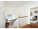 Bright stairway with hardwood floors, white banister, and view into sunlit bedroom with fireplace at 19 Oak Dr, Durham, NC 27707