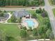 Aerial view of a community pool surrounded by lush landscaping and mature trees at 20 Paddy Ln, Youngsville, NC 27596