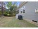 A partially shaded backyard with a screened-in porch and grill offer a relaxing retreat at 20 Paddy Ln, Youngsville, NC 27596