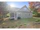 View of the backyard featuring a screened in porch, grill, lawn and landscaped area at 20 Paddy Ln, Youngsville, NC 27596