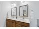 Bathroom featuring double sinks, decorative mirrors, and modern fixtures at 20 Paddy Ln, Youngsville, NC 27596
