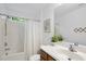 Bathroom featuring a shower with a curtain, single sink with storage, and light from a small window at 20 Paddy Ln, Youngsville, NC 27596