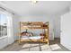 Bedroom featuring bunk beds, closet space, and a sunlit window at 20 Paddy Ln, Youngsville, NC 27596