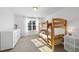 Bedroom featuring bunk beds, closet space, and a sunlit window at 20 Paddy Ln, Youngsville, NC 27596