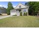 Charming two-story home with a well-manicured lawn, a garage, and stairs leading to the front porch at 20 Paddy Ln, Youngsville, NC 27596