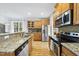Modern kitchen with stainless appliances, granite counters, and light wood cabinetry at 20 Paddy Ln, Youngsville, NC 27596