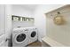 Convenient laundry room features washer, dryer, storage shelves, and coat hooks at 20 Paddy Ln, Youngsville, NC 27596