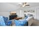 Bright living room with a ceiling fan, white shelves, and mounted television at 20 Paddy Ln, Youngsville, NC 27596