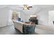 Bright living room featuring a floral sofa, a ceiling fan, and a mounted television at 20 Paddy Ln, Youngsville, NC 27596