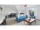 Cozy living room featuring a floral sofa, a ceiling fan, and a writing desk at 20 Paddy Ln, Youngsville, NC 27596