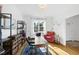 Well-lit office featuring hardwood floors, shelves, large window, and comfortable seating at 20 Paddy Ln, Youngsville, NC 27596