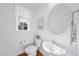 Modern powder room with stylish fixtures, round mirror, and natural light at 20 Paddy Ln, Youngsville, NC 27596