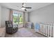 Cozy Bedroom with a rocking chair, crib, and natural light at 2013 Waterton Ln, Apex, NC 27502
