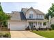 Charming two-story home featuring a garage and covered front porch with curb appeal at 2013 Waterton Ln, Apex, NC 27502