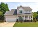 Charming two-story home featuring a garage and covered front porch with curb appeal at 2013 Waterton Ln, Apex, NC 27502