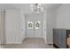 Bright foyer featuring double doors with decorative wreath accents and light hardwood flooring at 2013 Waterton Ln, Apex, NC 27502