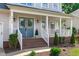 Charming exterior with blue front door, brick steps, and a welcoming porch with a swing at 2013 Waterton Ln, Apex, NC 27502