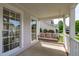 Inviting front porch featuring a charming porch swing with comfortable beige pillows at 2013 Waterton Ln, Apex, NC 27502