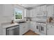 Updated kitchen featuring white cabinets, stainless steel appliances, and a window view at 2013 Waterton Ln, Apex, NC 27502