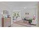 Open living space leading into dining area with large area rug and neutral walls at 2013 Waterton Ln, Apex, NC 27502