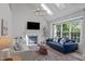 Sun-filled living room featuring a fireplace, large windows, and comfortable seating at 2013 Waterton Ln, Apex, NC 27502