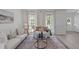 Cozy living room with plush seating, decorative pillows, and natural light streaming through large windows at 2013 Waterton Ln, Apex, NC 27502