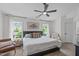 Bright main bedroom featuring a ceiling fan, large windows, and inviting decor at 2013 Waterton Ln, Apex, NC 27502