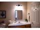 Bathroom with ample counter space, cabinet storage, decorative features, and a three-light vanity fixture at 205 Windbyrne Dr, Cary, NC 27513