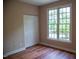Bedroom features wood floors, closet and a large window at 205 Windbyrne Dr, Cary, NC 27513