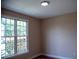 Bright bedroom with hardwood floors, a large window, and neutral paint at 205 Windbyrne Dr, Cary, NC 27513