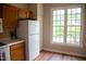 Kitchen area with wood cabinets and white refrigerator at 205 Windbyrne Dr, Cary, NC 27513