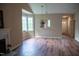 Open-concept living room featuring hardwood floors, fireplace, and seamless view into kitchen at 205 Windbyrne Dr, Cary, NC 27513